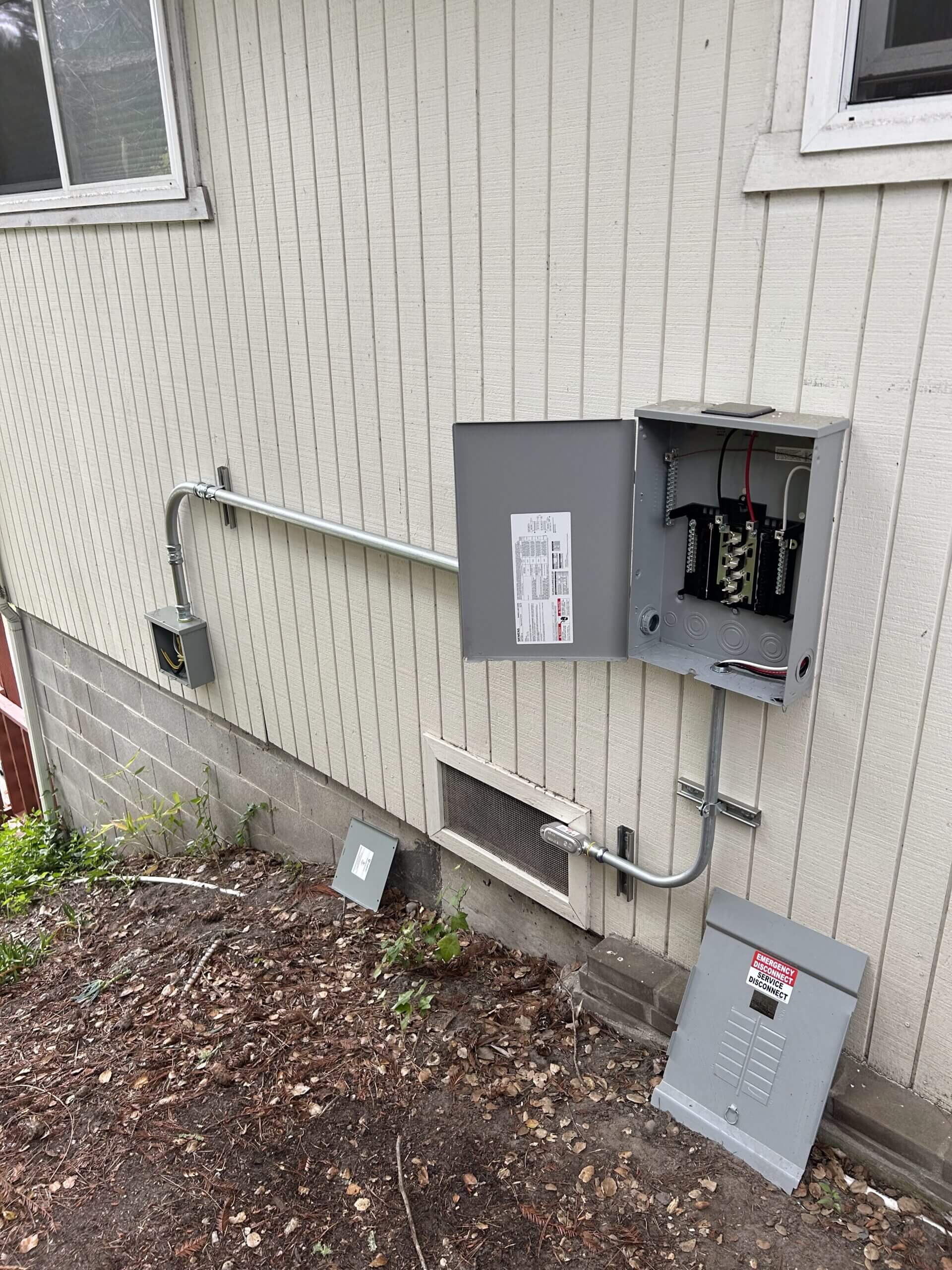 MP Electric technician working on an electrical panel in a Santa Cruz home